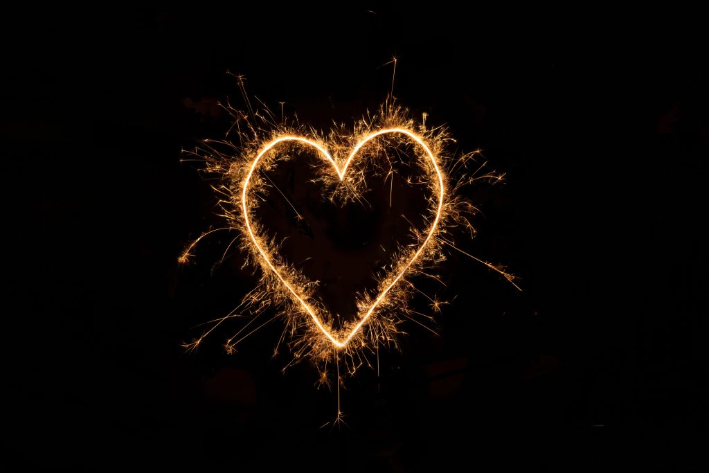 black background with a sparking heart in the center